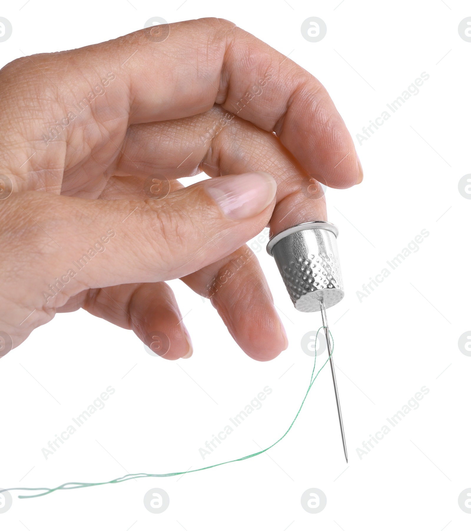 Photo of Woman with thimble and sewing needle on white background, closeup