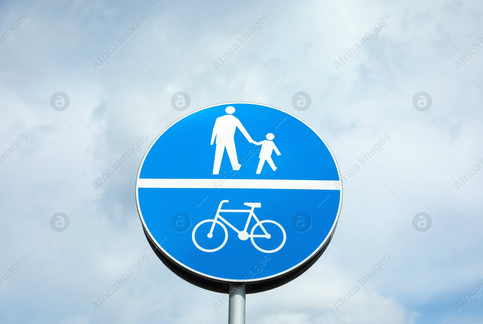 Photo of Traffic sign Compulsory Track For Pedestrians and Bicycles against blue sky