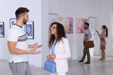 Happy couple at exhibition in art gallery