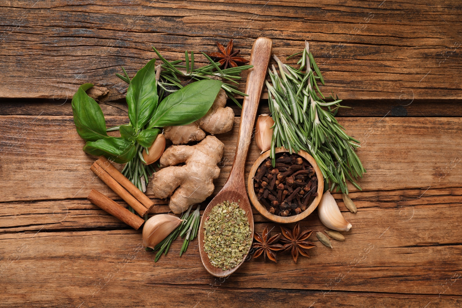 Photo of Flat lay composition with different natural spices and herbs on wooden table