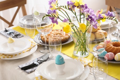 Photo of Festive Easter table setting with traditional meal at home