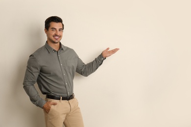 Photo of Young male teacher on beige background. Space for text
