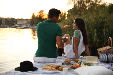 Happy couple spending time on pier at picnic