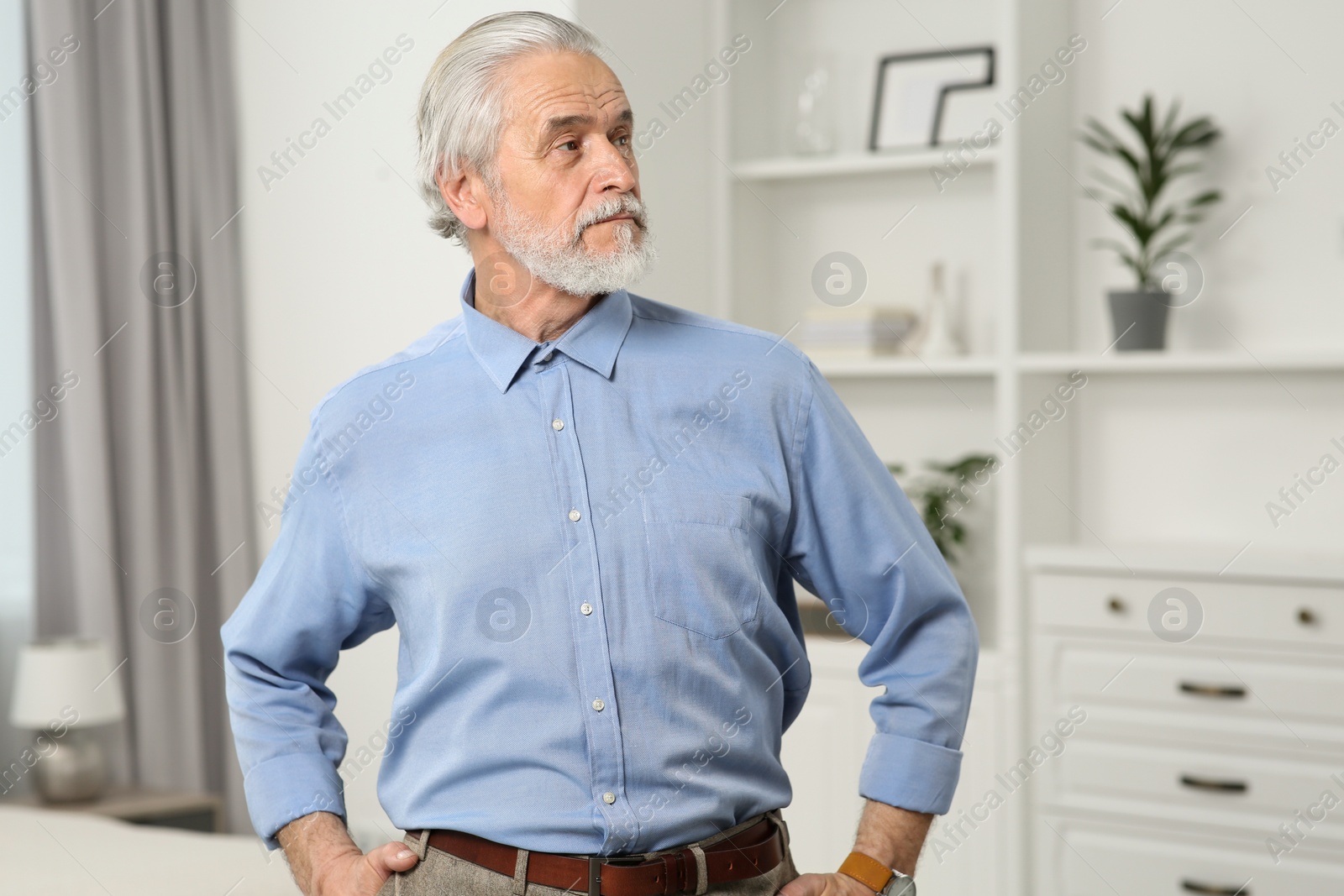 Photo of Portrait of handsome senior man at home