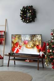 Stylish living room interior with modern TV and Christmas decor