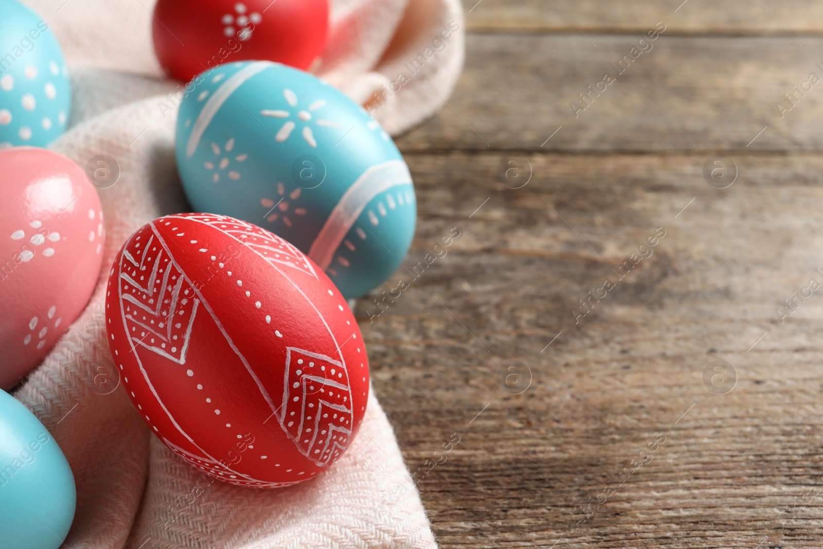 Photo of Colorful painted Easter eggs on wooden table. Space for text