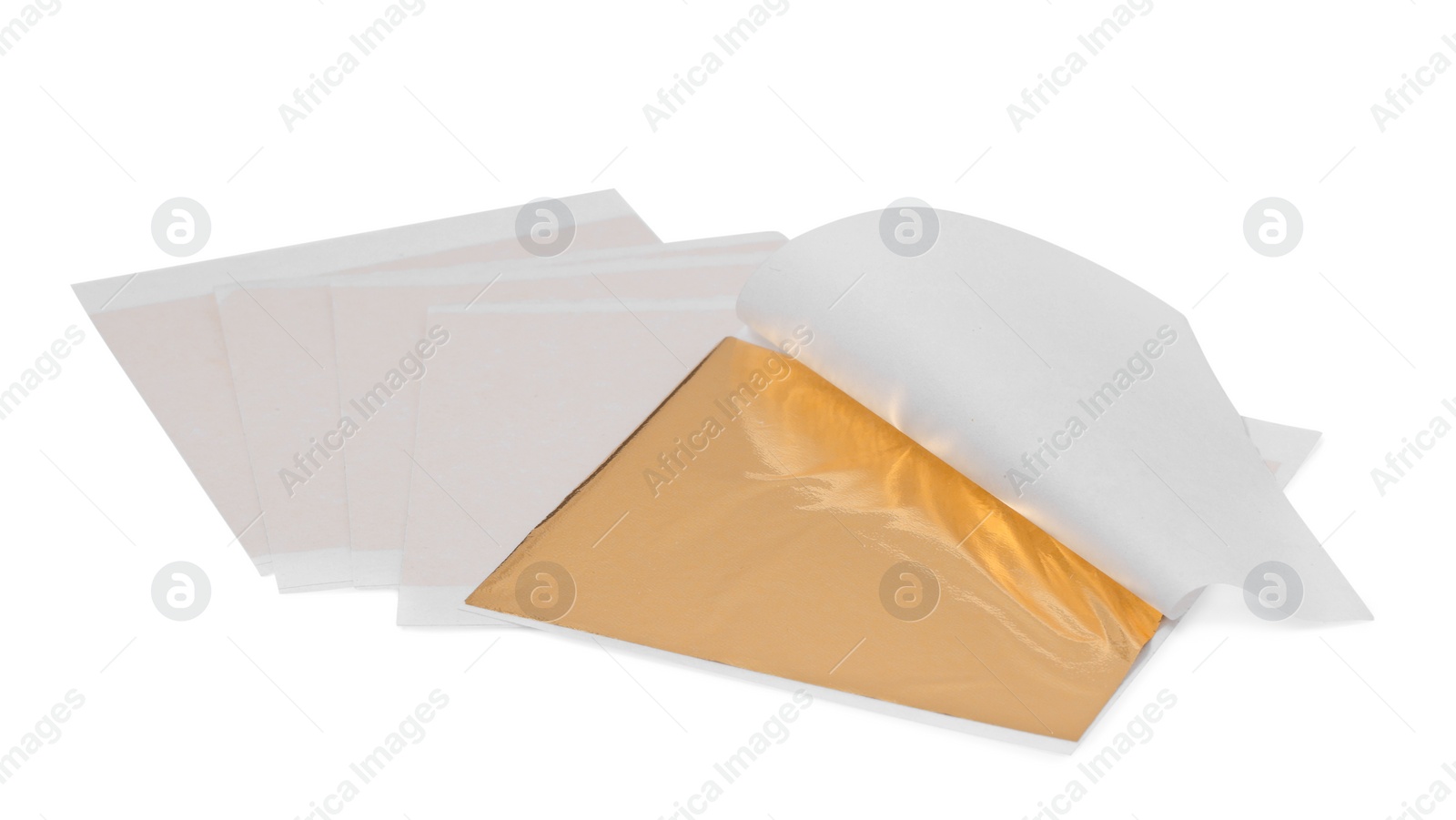 Many edible gold leaf sheets on white background Photo of Many edible gold leaf sheets on white background