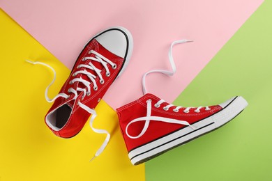 Photo of Pair of trendy sneakers on color background, flat lay