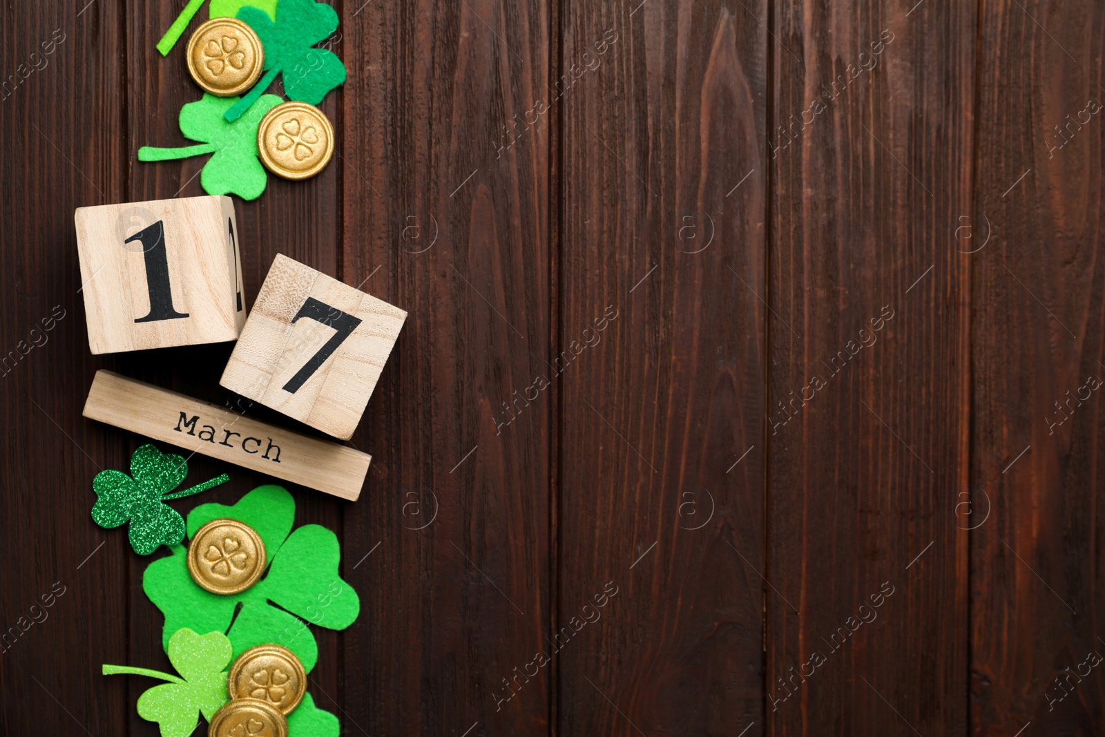 Photo of Flat lay composition with block calendar on wooden background, space for text. St. Patrick's Day celebration