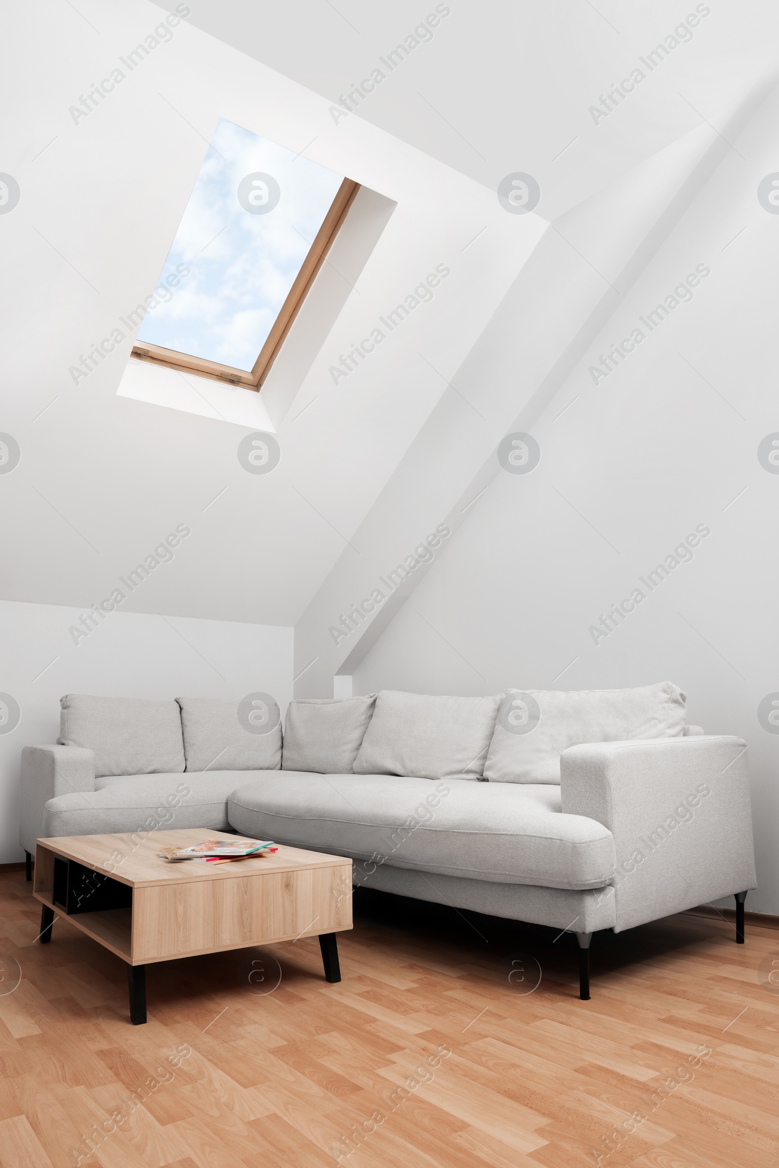 Photo of Attic room interior with slanted ceiling and furniture