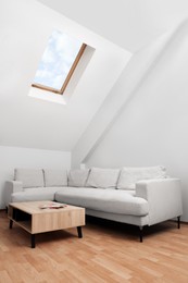 Photo of Attic room interior with slanted ceiling and furniture