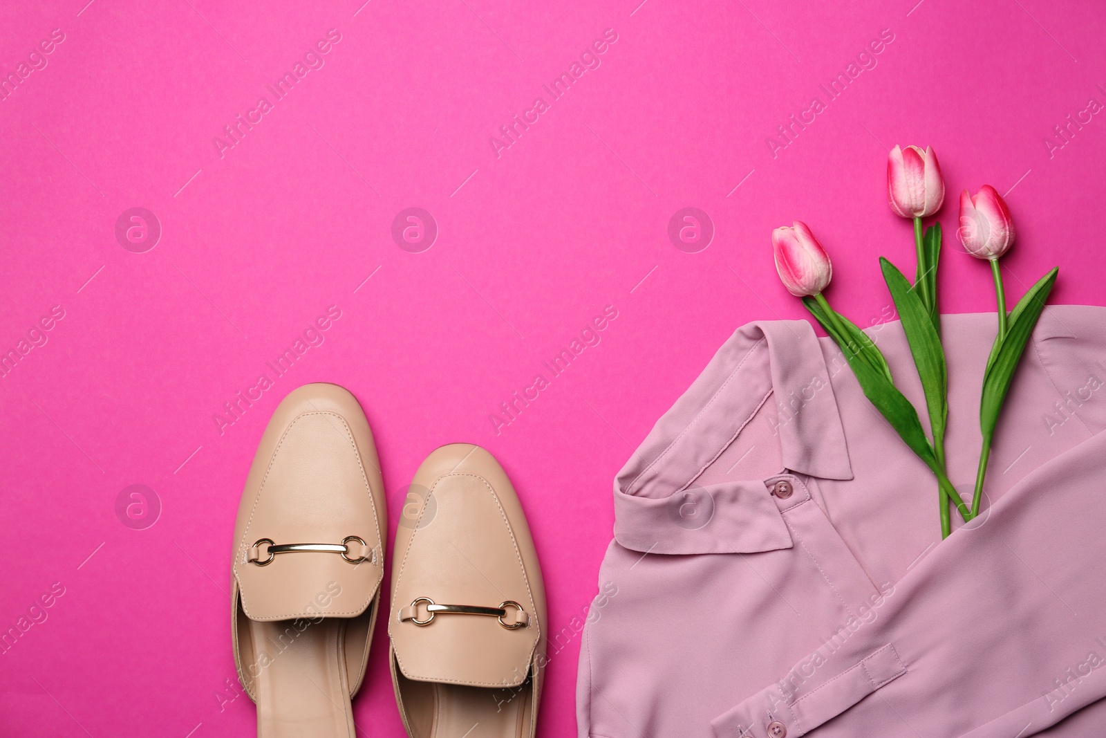 Photo of Stylish shirt, shoes and tulip flowers on pink background, flat lay. Space for text