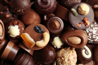 Photo of Many different tasty chocolate candies as background