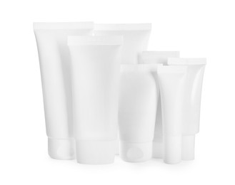 Photo of Blank tubes and jars of cosmetic products on white background