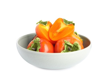 Photo of Bowl with delicious fresh persimmons isolated on white