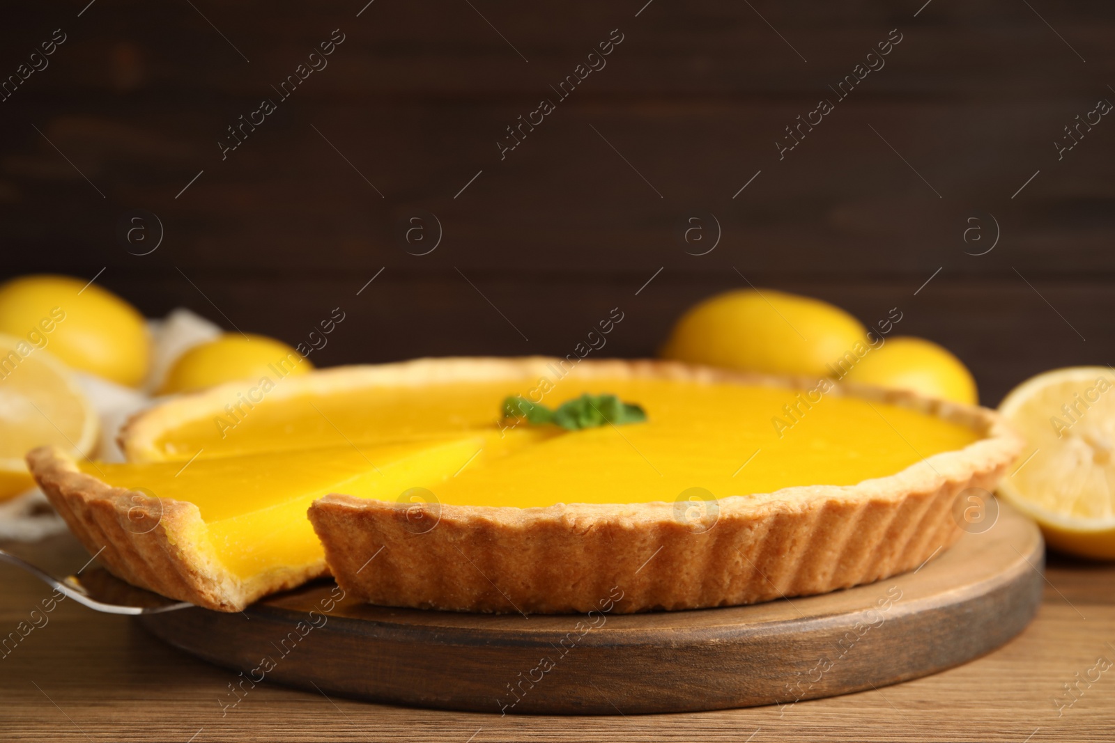 Photo of Delicious homemade lemon pie on wooden table