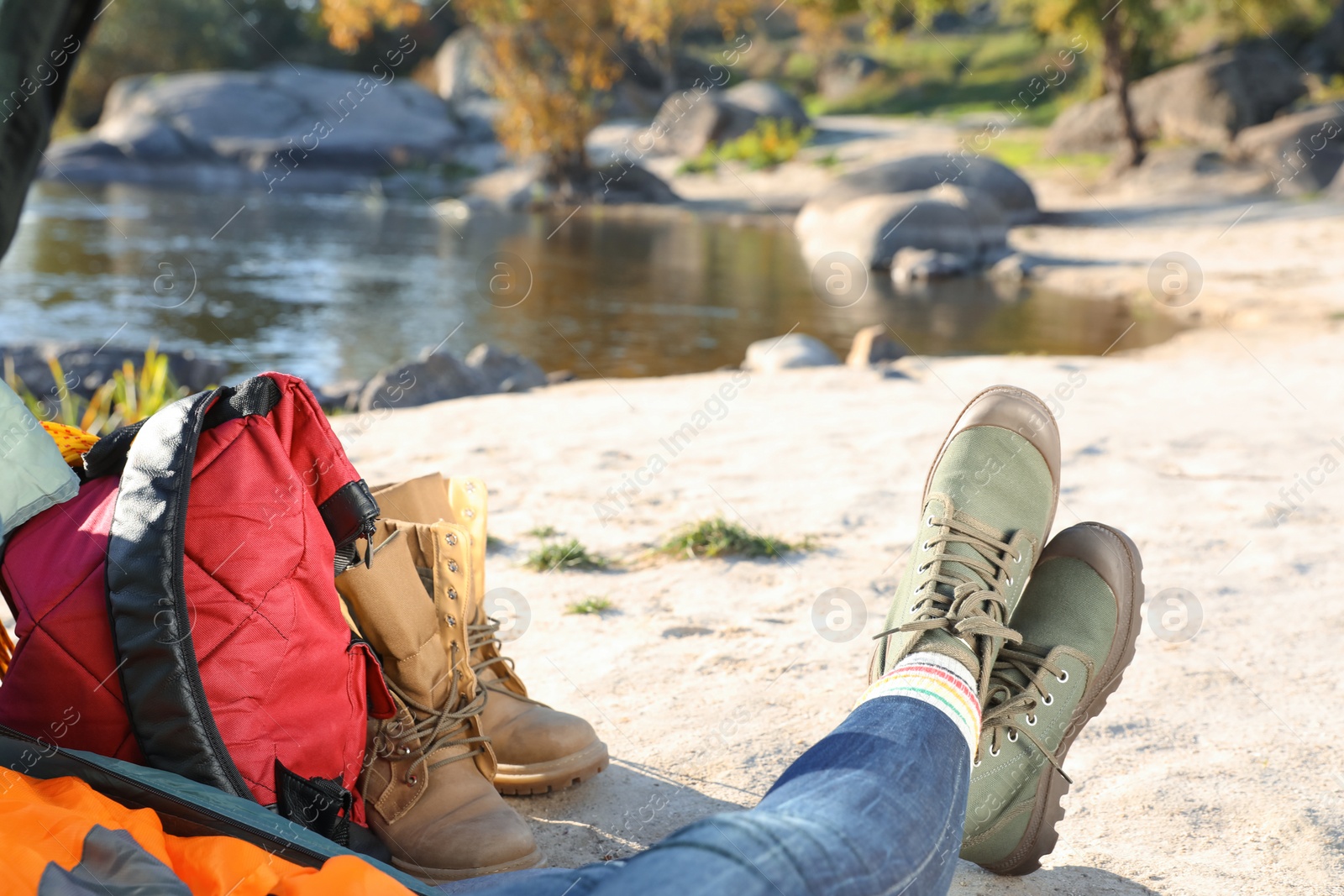 Photo of Woman lying on sleeping bag inside of camping tent, closeup