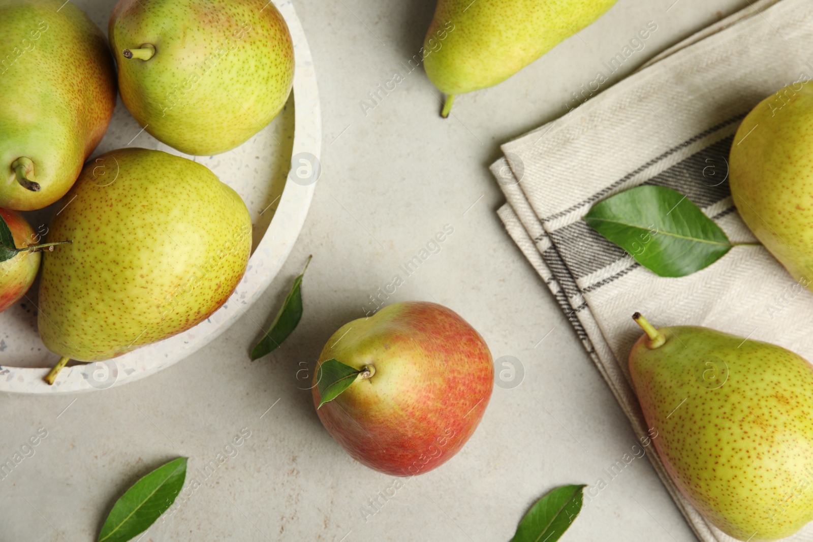 Photo of Ripe juicy pears on grey stone table, flat lay