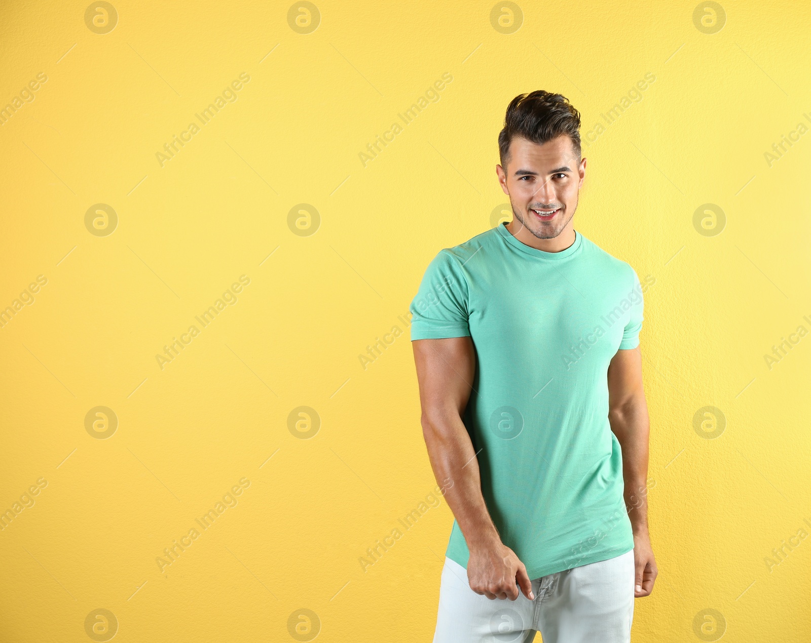 Photo of Young man in t-shirt on color background. Mockup for design