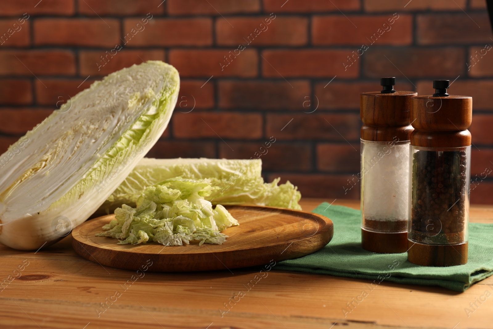 Photo of Fresh Chinese cabbage and spices on wooden table