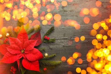 Image of Flat lay composition with traditional Christmas poinsettia flower and space for text on grey table, bokeh effect
