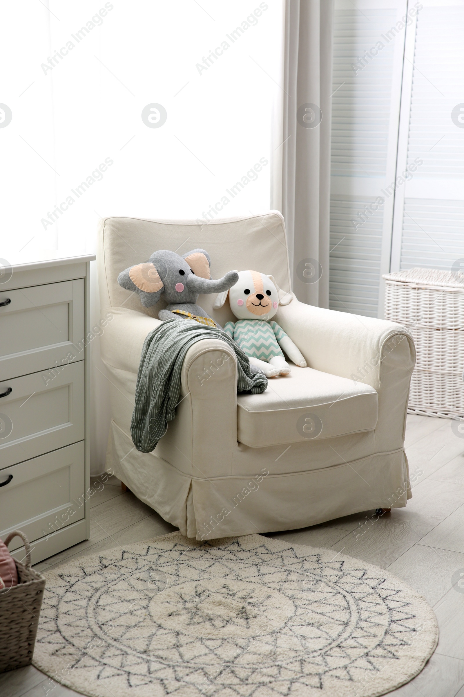 Photo of Comfortable armchair in modern baby room interior