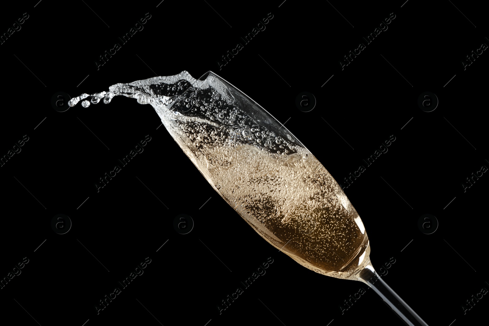 Photo of Glass of fizzy champagne on black background, closeup