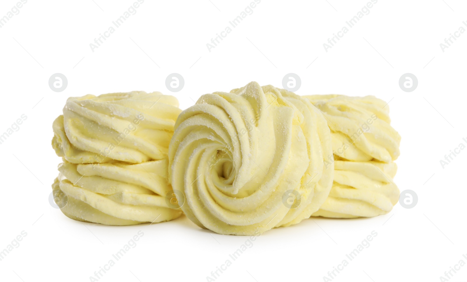 Photo of Many delicious yellow zephyrs on white background