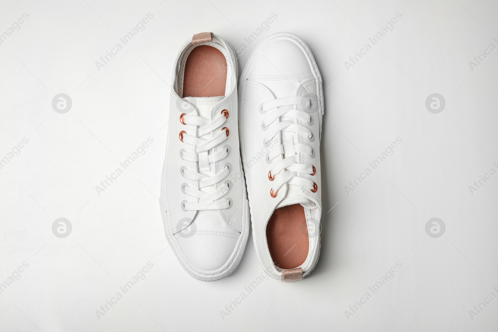 Photo of Pair of casual shoes on white background