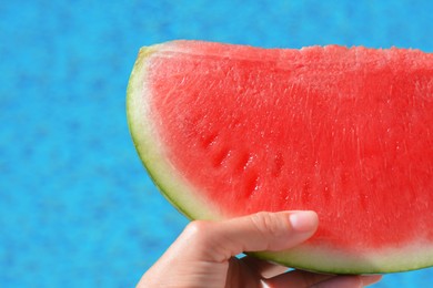 Photo of Woman holding watermelon near swimming pool outdoors, closeup