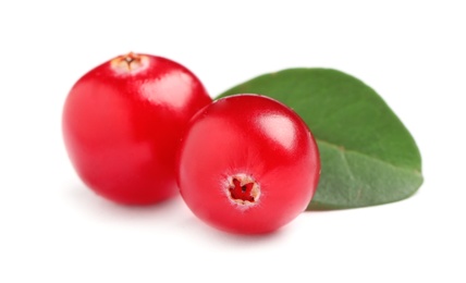Photo of Fresh cranberries with green leaf on white background