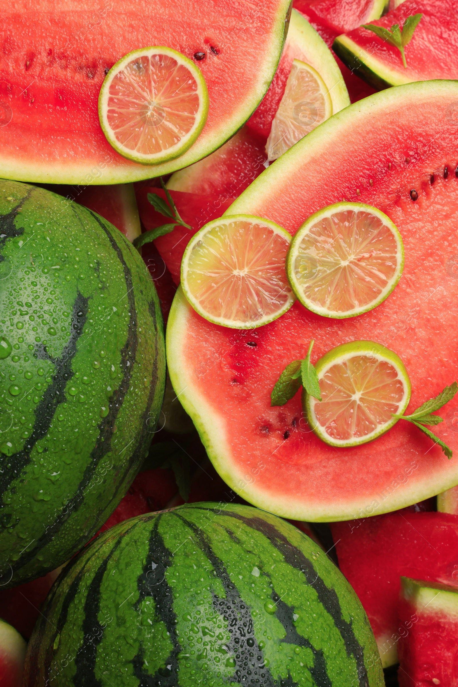 Photo of Juicy watermelon with lime and mint as background, top view