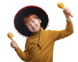 Photo of Cute boy in Mexican sombrero hat dancing with maracas on white background