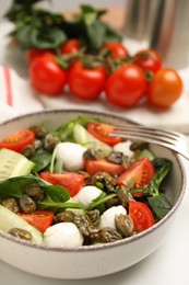 Photo of Salad with vegetables, capers and mozzarella in bowl, closeup