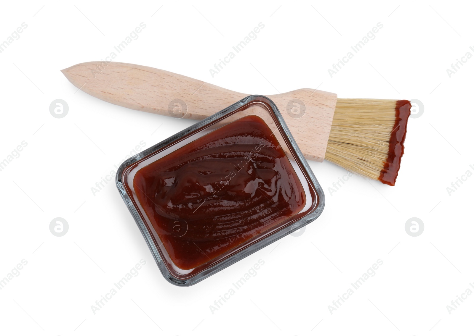 Photo of Marinade in bowl and basting brush isolated on white, top view