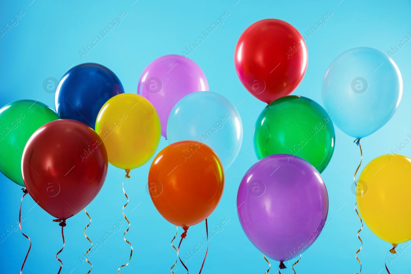 Photo of Bright balloons on color background. Celebration time