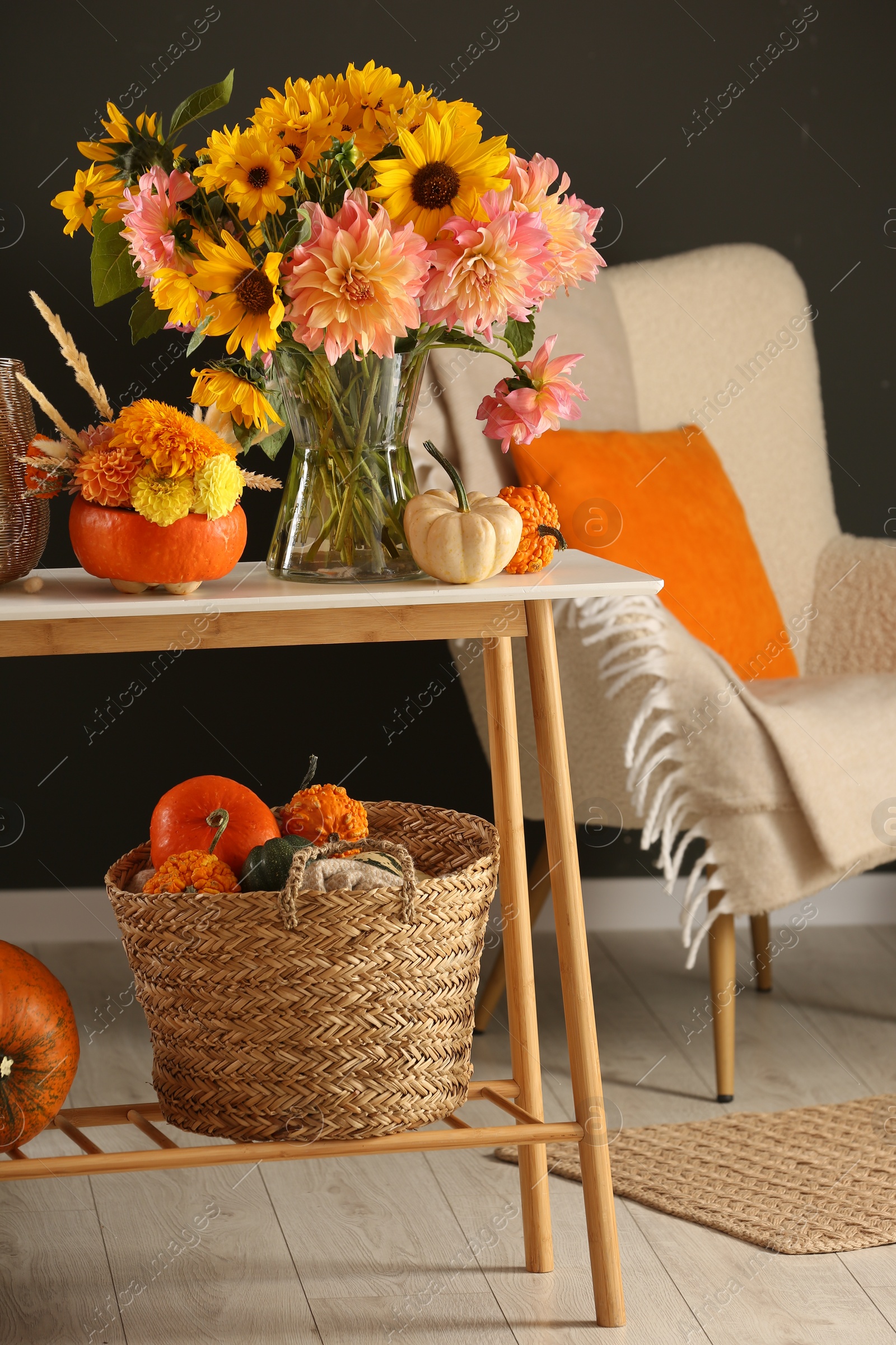 Photo of Room decorated with pumpkins and bright flowers. Autumn vibes