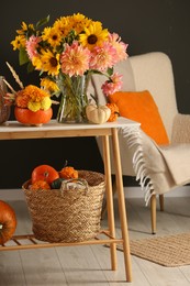 Room decorated with pumpkins and bright flowers. Autumn vibes