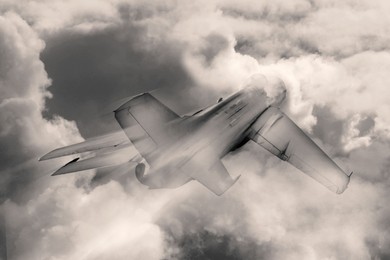 Image of Jet fighter flying in sky with fluffy clouds