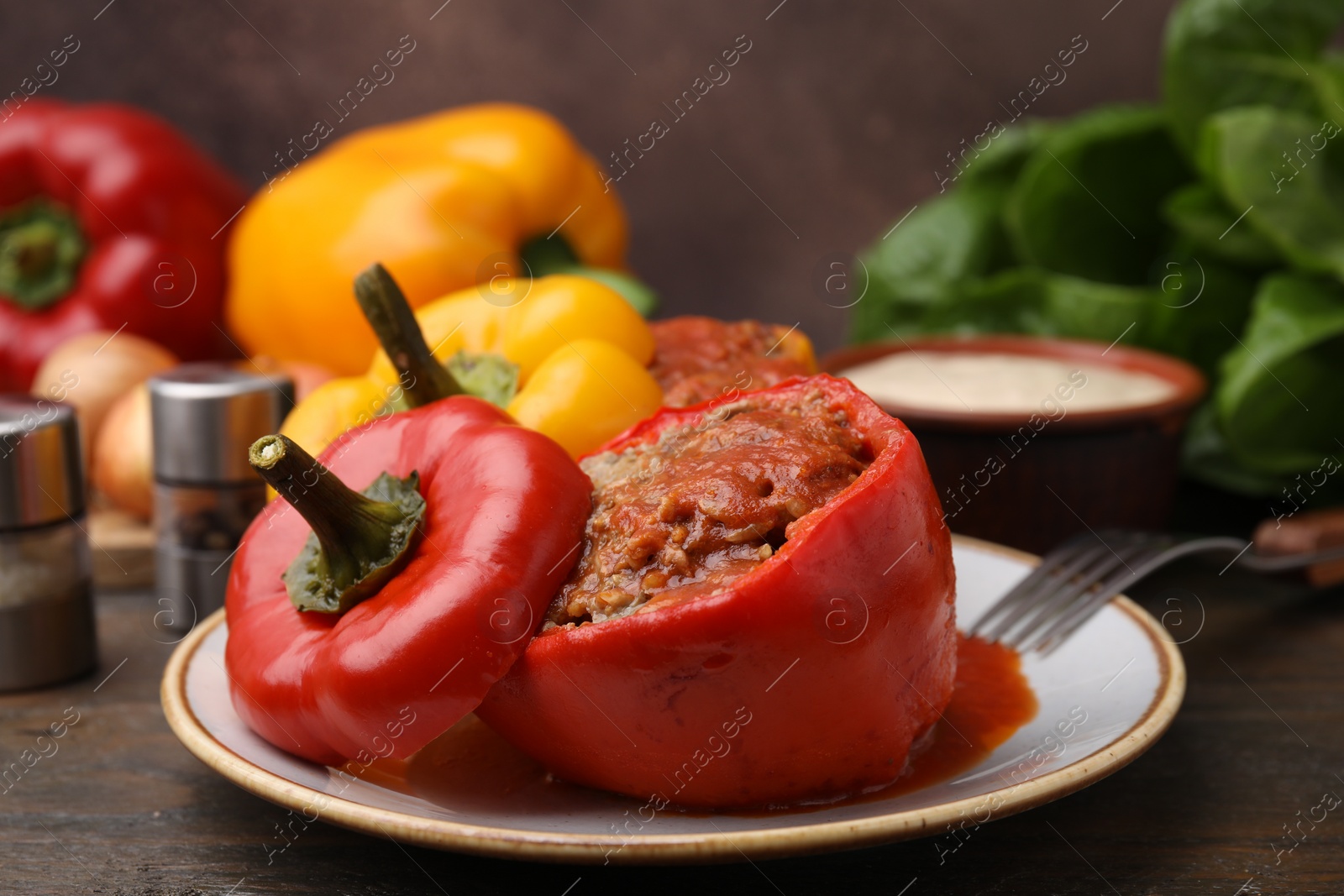 Photo of Delicious stuffed bell peppers served on wooden table