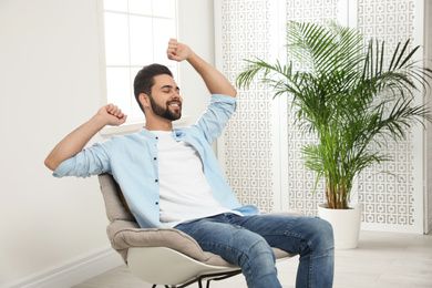 Photo of Young man relaxing at home. Peaceful rest