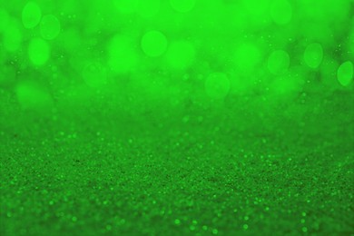 Image of St. Patrick day. Shiny green glitter, closeup. Bokeh effect