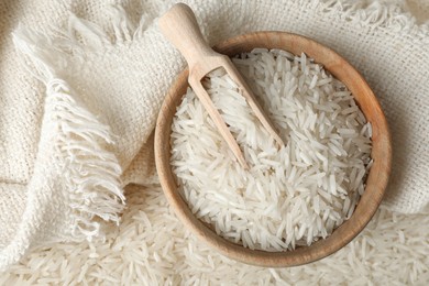 Photo of Raw basmati rice, bowl and scoop, top view