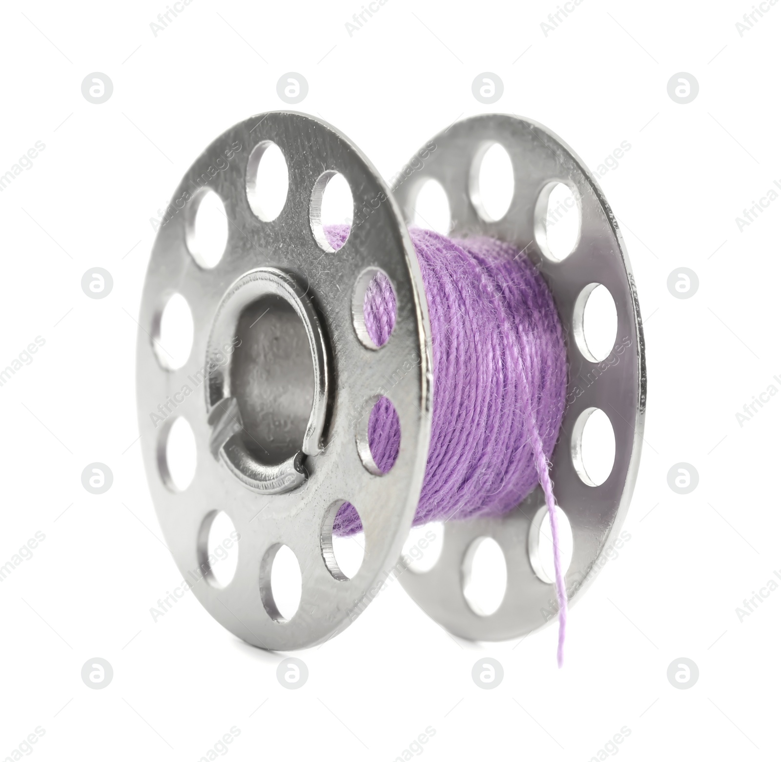 Photo of Metal spool of violet sewing thread isolated on white