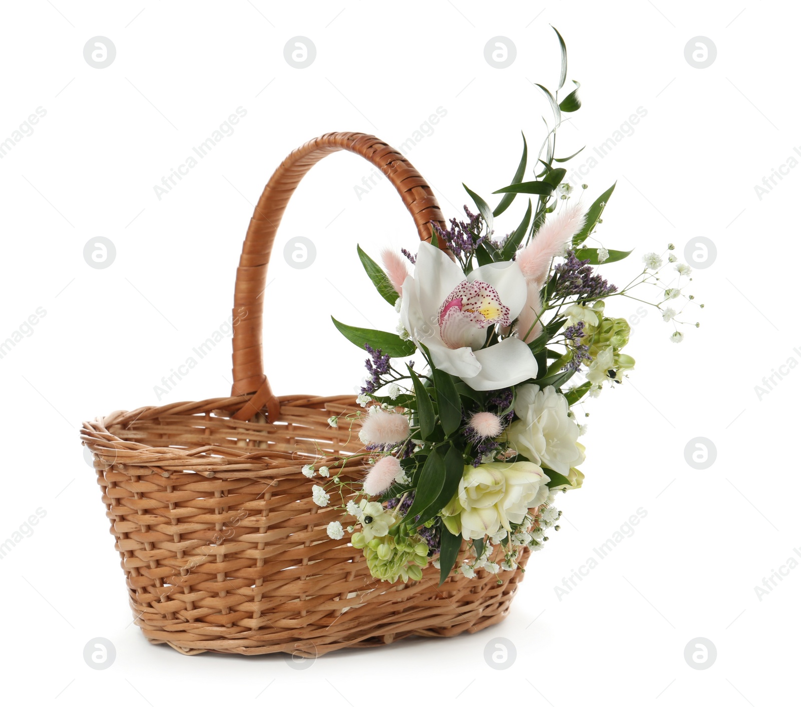 Photo of Wicker basket decorated with beautiful flowers on white background. Easter item