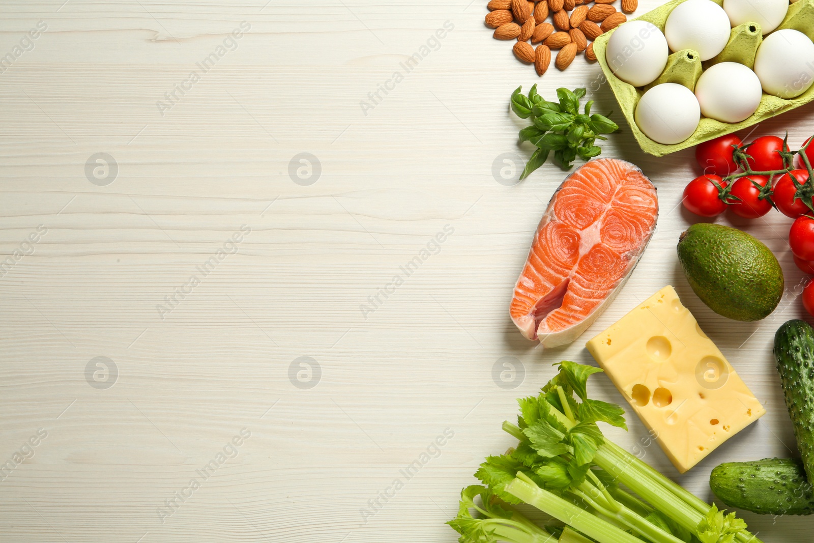 Photo of Flat lay composition with fresh organic products on white wooden table, space for text. Keto diet