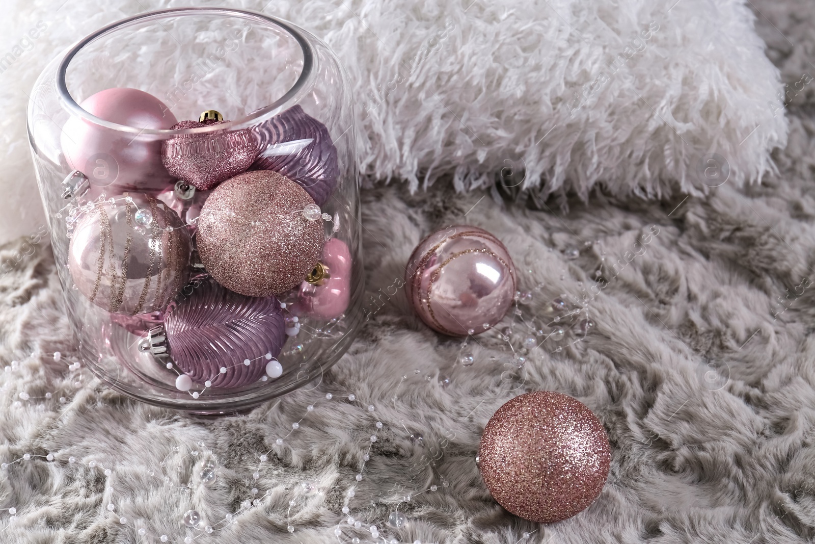 Photo of Beautiful pink Christmas baubles on grey fur