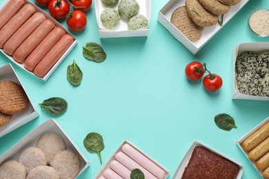 Flat lay composition with different vegan meat products and tomatoes on turquoise background. Space for text