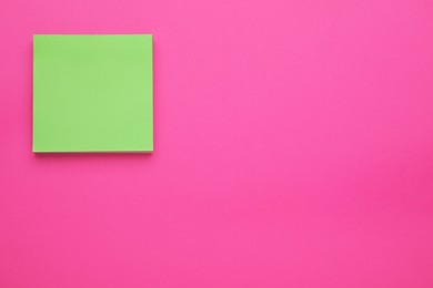 Empty notes on pink background, top view. Space for text