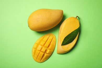 Photo of Flat lay composition with mango fruits on color background